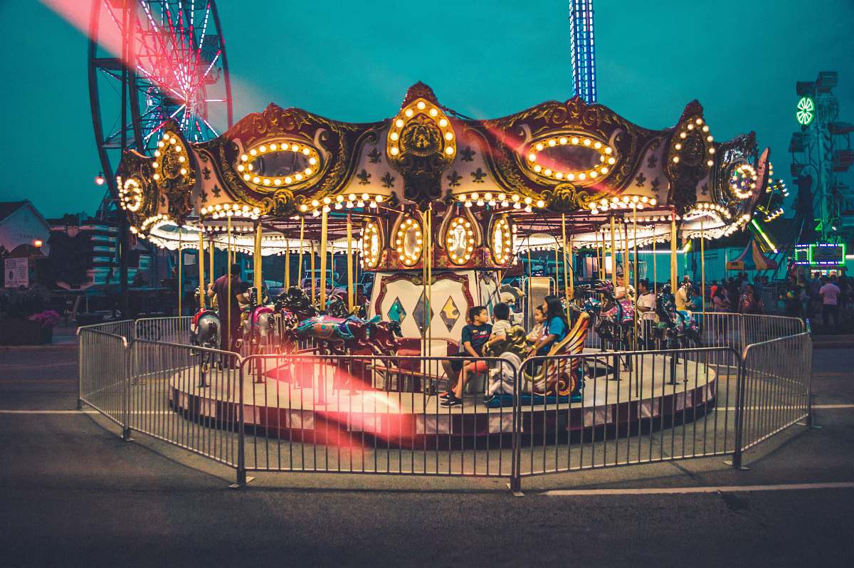 amusement park carousel in middle of theme park during nighttime leisure activities